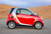 AUT 44 RK0086 01
2009 Smart Fortwo Passion Coupe Red And Silver Profile View On Pavement By Hills