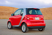 AUT 44 RK0088 01
2009 Smart Fortwo Passion Coupe Red And Silver 3/4 Rear View On Pavement By Hills