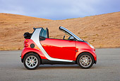 AUT 44 RK0092 01
2009 Smart Fortwo Passion Cabriolet Red And Silver Profile View On Pavement By Hills