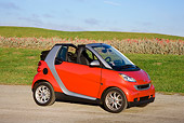 AUT 44 RK0094 01
2009 Smart Fortwo Passion Cabriolet Red And Silver 3/4 Front View On Pavement By Field
