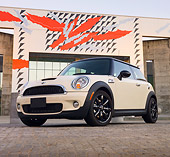 AUT 45 BK0008 01
2010 Mini Cooper S White 3/4 Front View On Brick By Building