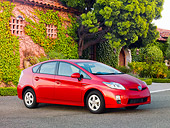 AUT 45 RK0024 01
2010 Toyota Prius Hybrid Red 3/4 Front View On Pavement By Building
