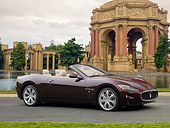 AUT 45 RK0082 01
2010 Maserati GranTurismo Convertible Burgundy 3/4 Side View On Grass By Building