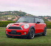 AUT 46 BK0001 01
2013 Mini Cooper Clubman S Red With Black Stripes 3/4 Front View On Grass By Hills
