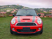 AUT 46 BK0002 01
2013 Mini Cooper Clubman S Red With Black Stripes Head On View On Grass By Hills