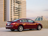 AUT 46 BK0003 01
2011 Nissan Maxima 3.5 SV Premium Red 3/4 Rear View In Parking Lot By Building