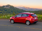 AUT 46 BK0016 01
2011 Ford Fiesta Red 3/4 Rear View On Road By Mountains At Dusk