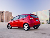 AUT 46 BK0017 01
2011 Ford Fiesta Red 3/4 Rear View On Pavement By Buildings