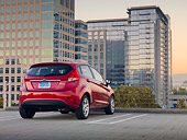 AUT 46 BK0019 01
2011 Ford Fiesta Red 3/4 Rear View On Pavement By Buildings