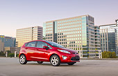 AUT 46 BK0021 01
2011 Ford Fiesta Red 3/4 Side View On Pavement By Buildings