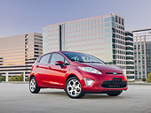 AUT 46 BK0022 01
2011 Ford Fiesta Red 3/4 Front View On Pavement By Buildings