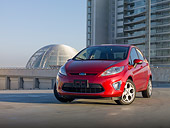 AUT 46 BK0024 01
2011 Ford Fiesta Red 3/4 Front View On Pavement By Buildings