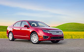 AUT 46 BK0045 01
2011 Ford Fusion Hybrid Red 3/4 Front View On Pavement By Field Of Wildflowers