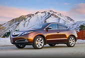 AUT 46 BK0053 01
2011 Acura ZDX Burnt Orange 3/4 Front View On Pavement By Snowy Mountains