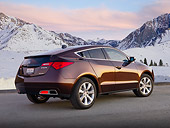 AUT 46 BK0055 01
2011 Acura ZDX Burnt Orange 3/4 Rear View On Pavement By Snowy Mountains