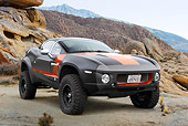 AUT 46 RK0120 01
2011 Local Motors Rally Fighter Black With Orange Stripe 3/4 Front View On Dirt In Desert