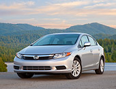 AUT 48 BK0002 01
2012 Honda Civic Silver 3/4 Front View On Pavement By Trees