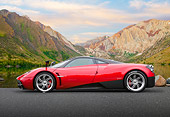 AUT 48 BK0014 01
2012 Pagani Huayra Red Profile View On Pavement By Pond And Mountains