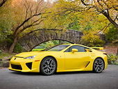AUT 48 RK0001 01
2012 Lexus LFA Coupe Yellow 3/4 Side View On Pavement By Autumn Trees And Stone Bridge