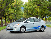 AUT 48 RK0021 01
2012 Toyota Prius Plug-In Hybrid Blue 3/4 Front View On Pavement By Autumn Trees