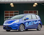 AUT 48 RK0063 01
2012 Honda Fit EV Blue 3/4 Front View On Pavement By Building