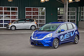 AUT 48 RK0064 01
2012 Honda Fit EV Blue 3/4 Front View On Pavement By Building