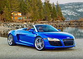 AUT 48 RK0076 01
2012 Audi R8 Spyder Blue 3/4 Front View On Pavement By Lake And Cabin