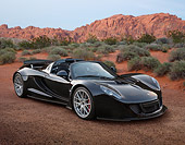 AUT 49 RK0007 01
2013 Hennessey Venom GT Spyder Black 3/4 Front View On Dirt In Desert