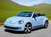 AUT 49 RK0009 01
2013 Volkswagen Beetle Covertible Turbo 60s Light Blue 3/4 Front View On Pavement By Grassy Hills