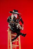 BRD 01 RC0004 01
Humorous Spanish Red Macaw Playing Guitar Sitting On Ladder Red Background Studio