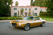 CAM 01 RK0204 01
1970 1/2 Chevrolet Camaro Z-28 Gold With Black Stripe 3/4 Front View On Pavement By House