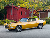 CAM 01 RK0211 01
1970 1/2 Chevrolet Camaro Z-28 Gold With Black Stripe 3/4 Side View On Pavement By Red Train