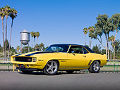 CAM 01 RK0220 01
1969 Chevrolet Camaro Z-28 Yellow With Black Stripes 3/4 Front View On Pavement By Palm Trees And Water Tower