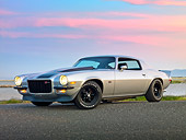 CAM 01 RK0250 01
1973 Chevrolet Camaro Z-28 Silver With Black Stripe 3/4 Front View On Pavement By Bay At Dusk