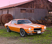 CAM 01 RK0164 01
1970 Chevrolet Camaro Z-28 Hugger Orange And White Stripe 3/4 Front View On Grass By Barn