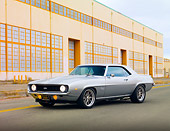 CAM 02 RK0056 01
1969 Chevrolet Camaro SS 454 Silver 3/4 Front View On Pavement By Building