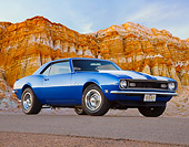 CAM 03 BK0004 01
1968 Chevrolet Camaro Blue With White Stripe 3/4 Front View On Pavement By Red Rock