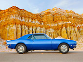 CAM 03 BK0005 01
1968 Chevrolet Camaro Blue With White Stripe Profile View On Road By Red Rock