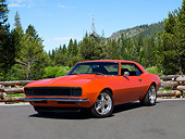 CAM 03 RK0216 01
1968 Chevrolet Camaro Orange 3/4 Front View On Pavement By Wooden Fence And Pine Trees