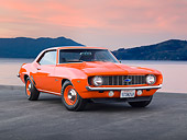 CAM 03 RK0219 01
1969 Chevrolet COPO Camaro Orange 3/4 Front View On Pavement By Lake At Sunset