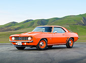 CAM 03 RK0221 01
1969 Chevrolet COPO Camaro Orange 3/4 Front View On Pavement By Grassy Hills