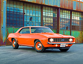 CAM 03 RK0222 01
1969 Chevrolet COPO Camaro Orange 3/4 Front View On Pavement By Old Factory Building