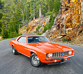 CAM 03 RK0226 01
1969 Chevrolet Camaro ZL-1 Orange 3/4 Front View On Pavement By Trees And Rocky Cliffside