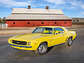 CAM 03 RK0240 01
1969 Chevrolet COPO Camaro RS Yellow 3/4 Front View On Pavement By Red Barn