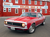 CAM 03 RK0257 01
1967 Chevrolet Camaro RS Red 3/4 Front View On Pavement By Bar-B-Q Restaurant