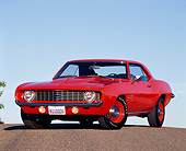 CAM 03 RK0007 01
1969 Chevrolet Camaro ZL-1 Hugger Orange 3/4 Front View On Pavement Hill Blue Sky