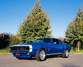 CAM 03 RK0077 02
1967 Chevrolet Camaro RS Aqua Blue Low 3/4 Front View On Pavement By Trees