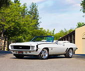 CAM 03 RK0176 01
1969 Chevrolet Camaro SS Convertible White 3/4 Front View By Trees Building