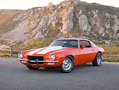 CAM 04 RK0135 01
1973 Chevrolet Camaro Orange And White Stripes 3/4 Front View On Pavement By Sand Dune