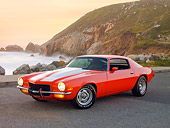 CAM 04 RK0137 01
1973 Chevrolet Camaro Orange And White Stripes 3/4 Front View On Pavement By Sand Dune
